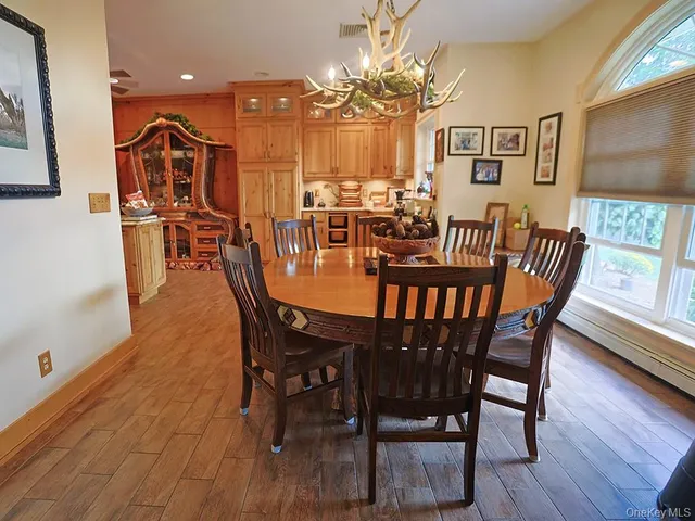 a view of a dining room with furniture and wooden floor