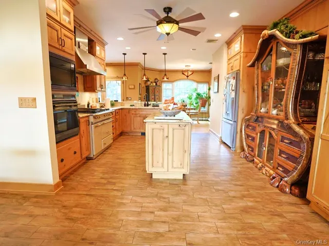 a kitchen with stainless steel appliances granite countertop a refrigerator a oven a sink and dishwasher