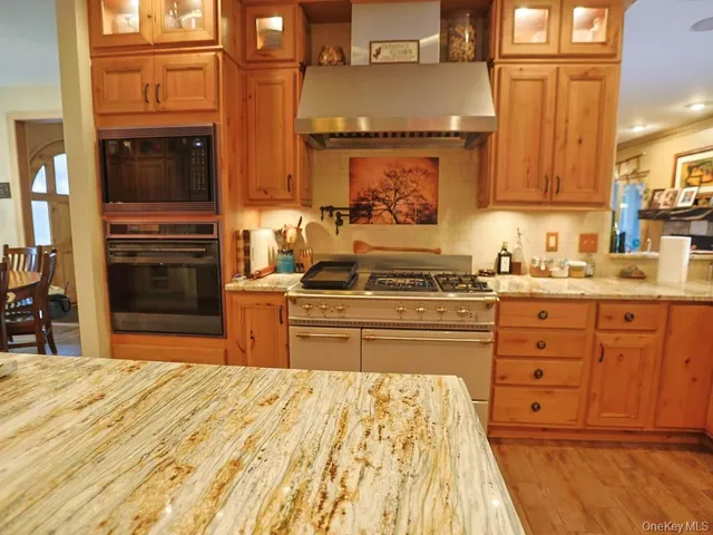 a kitchen with stainless steel appliances granite countertop a stove and a sink