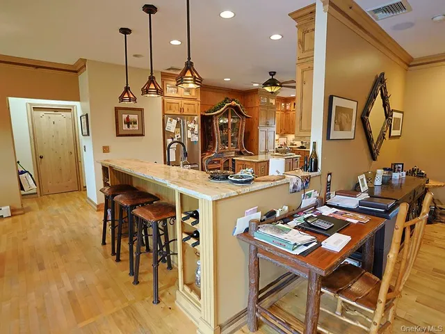 a room with stainless steel appliances kitchen island granite countertop furniture and a view of living room