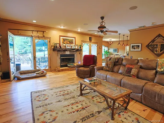 a living room with furniture gym equipment and a fireplace