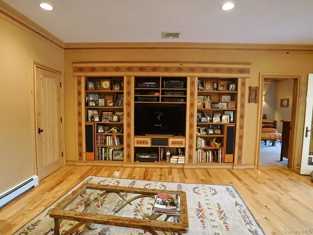 a living room with a flat screen tv and outdoor seating