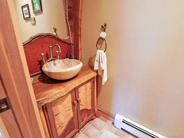 a bed sitting in a bedroom next to a lamp