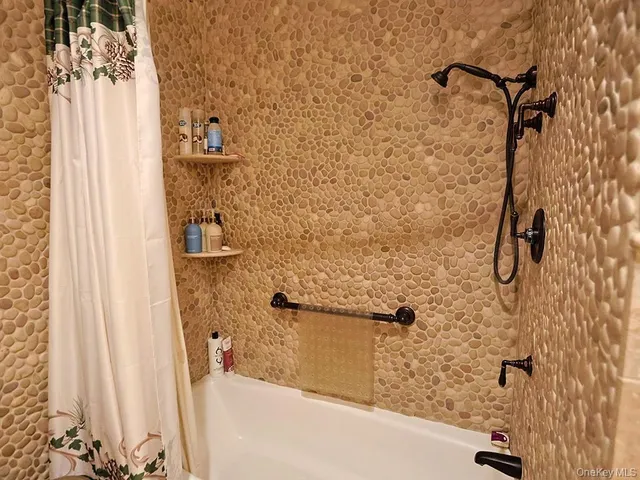 a bedroom with a bed and painting on the wall