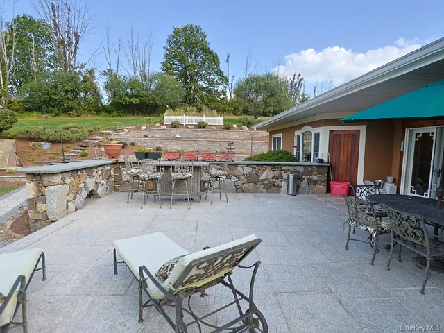 a balcony with furniture and a table