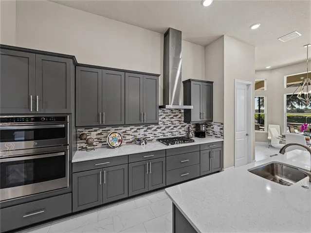 a living room with furniture and large windows