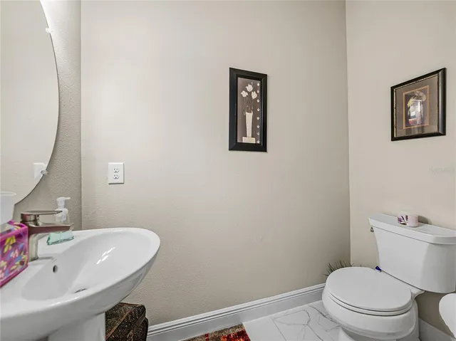 a bathroom with a granite countertop toilet sink and shower