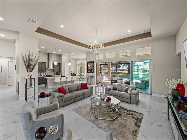 a living room with furniture and kitchen view