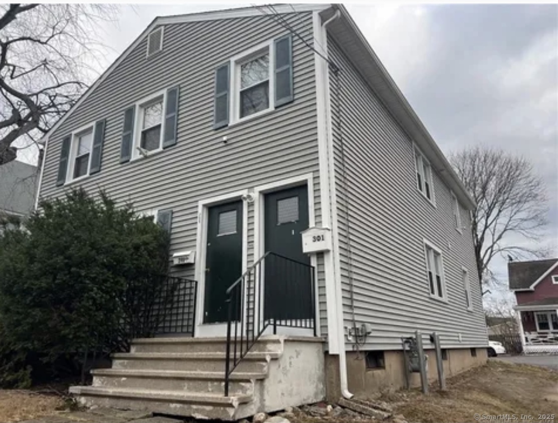 a front view of a house with stairs