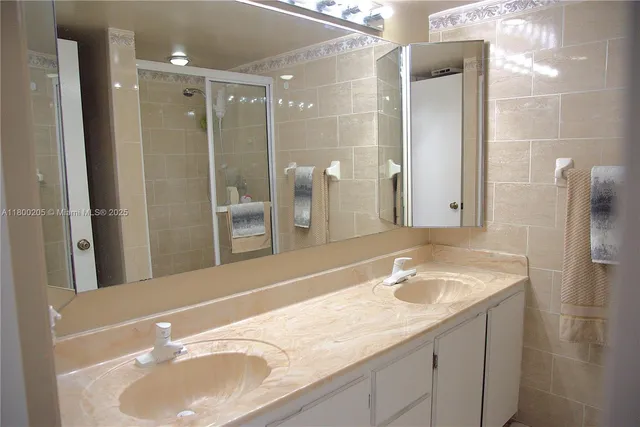 a bathroom with a sink double vanity and a shower