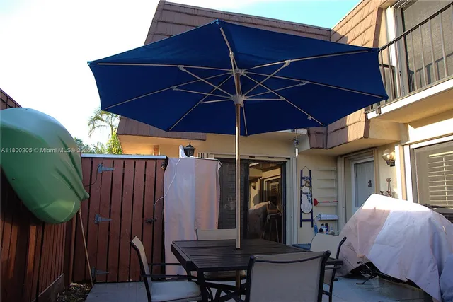 a view of a chair and table in the patio