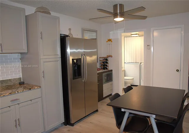 a kitchen with refrigerator and window
