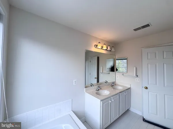 a bathroom with a sink a mirror and a bathtub
