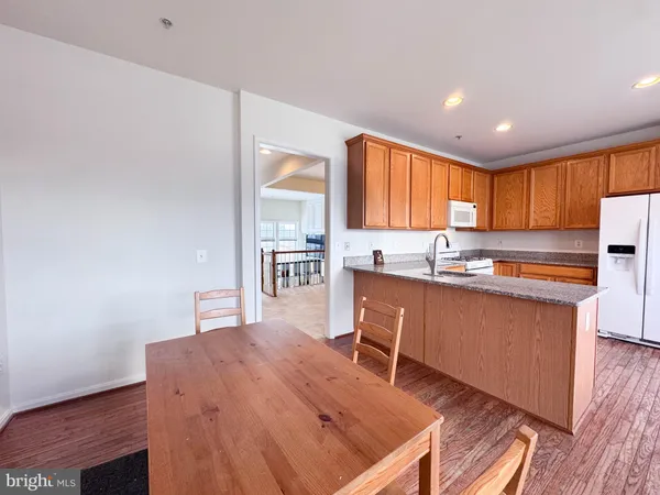a kitchen with stainless steel appliances granite countertop a sink and a refrigerator