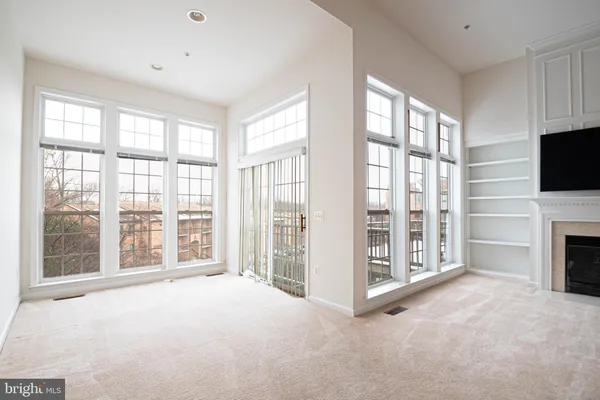 a view of livingroom with furniture flat screen tv and balcony