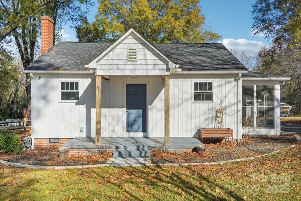 a front view of a house with a yard and seating space