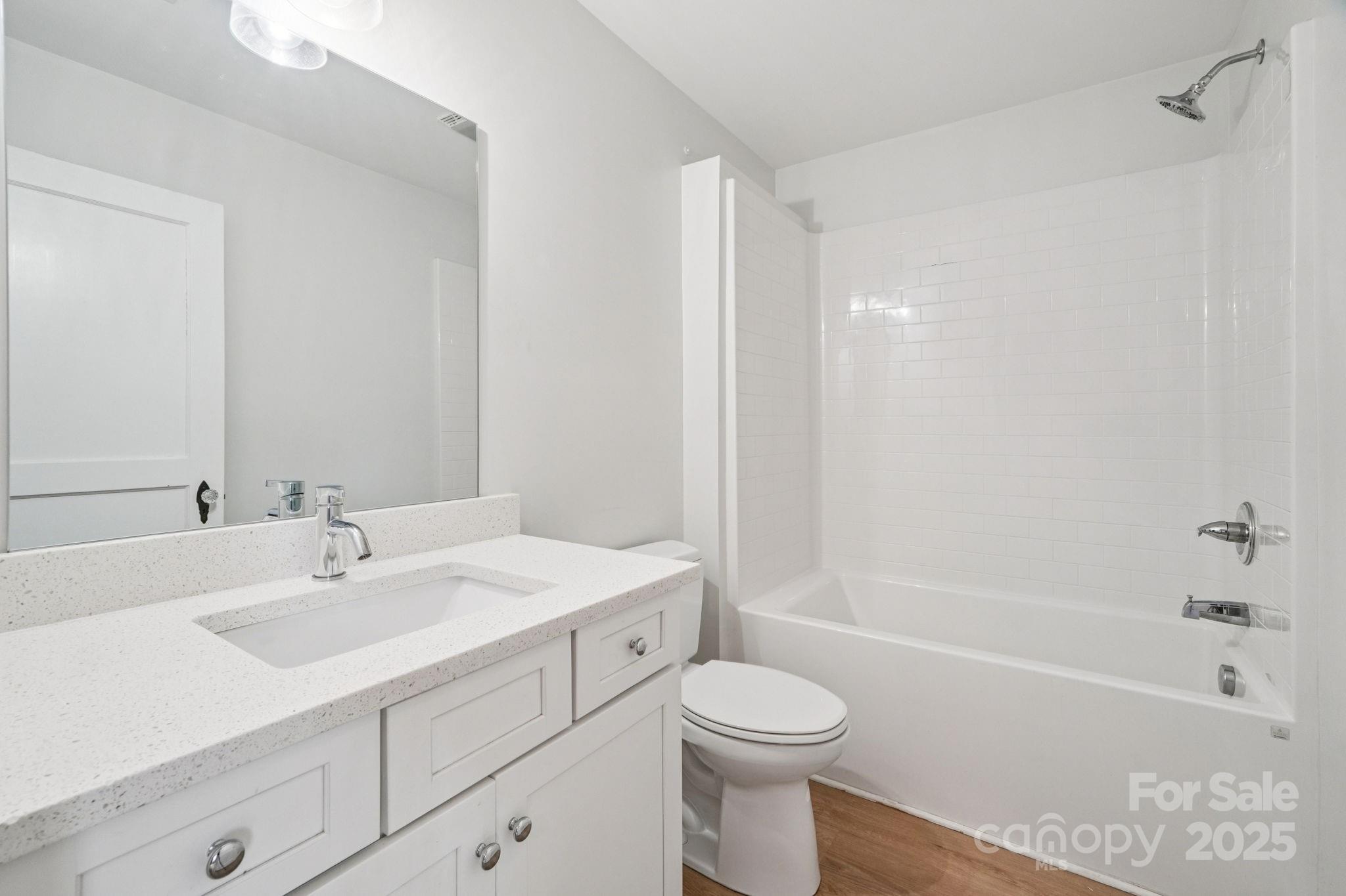 611 Sumner Street Kannapolis, NC 28083 - Photo 17 of 39 a bathroom with a sink a toilet and shower