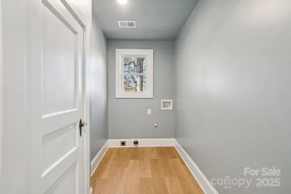 a view of a room with rack on the wall and a window