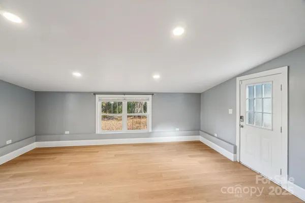 an empty room with windows and closet