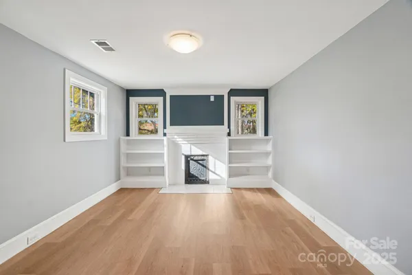 a view of a livingroom with wooden floor and a window
