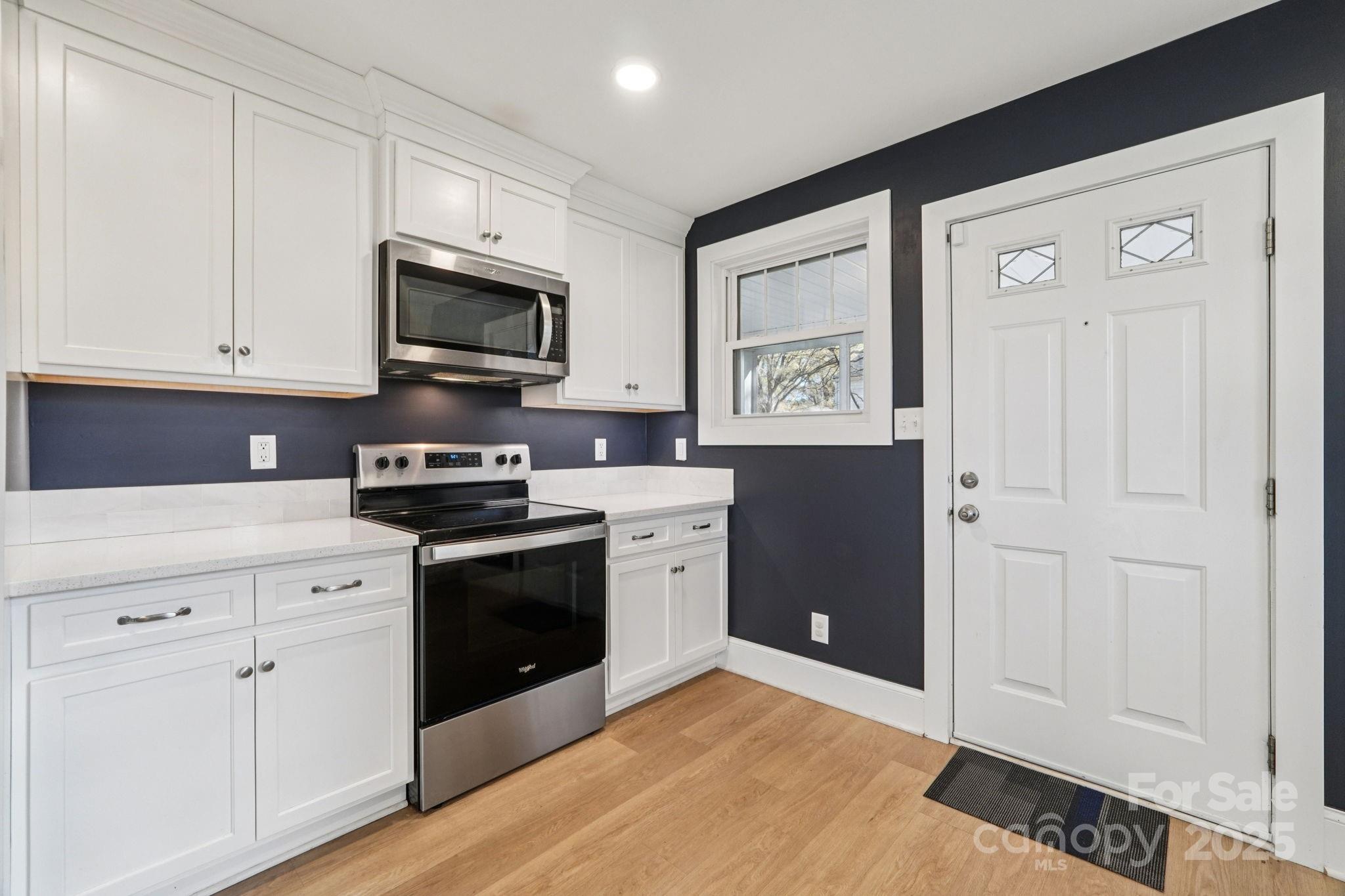 611 Sumner Street Kannapolis, NC 28083 - Photo 10 of 39 a kitchen with stainless steel appliances granite countertop white cabinets and black appliances