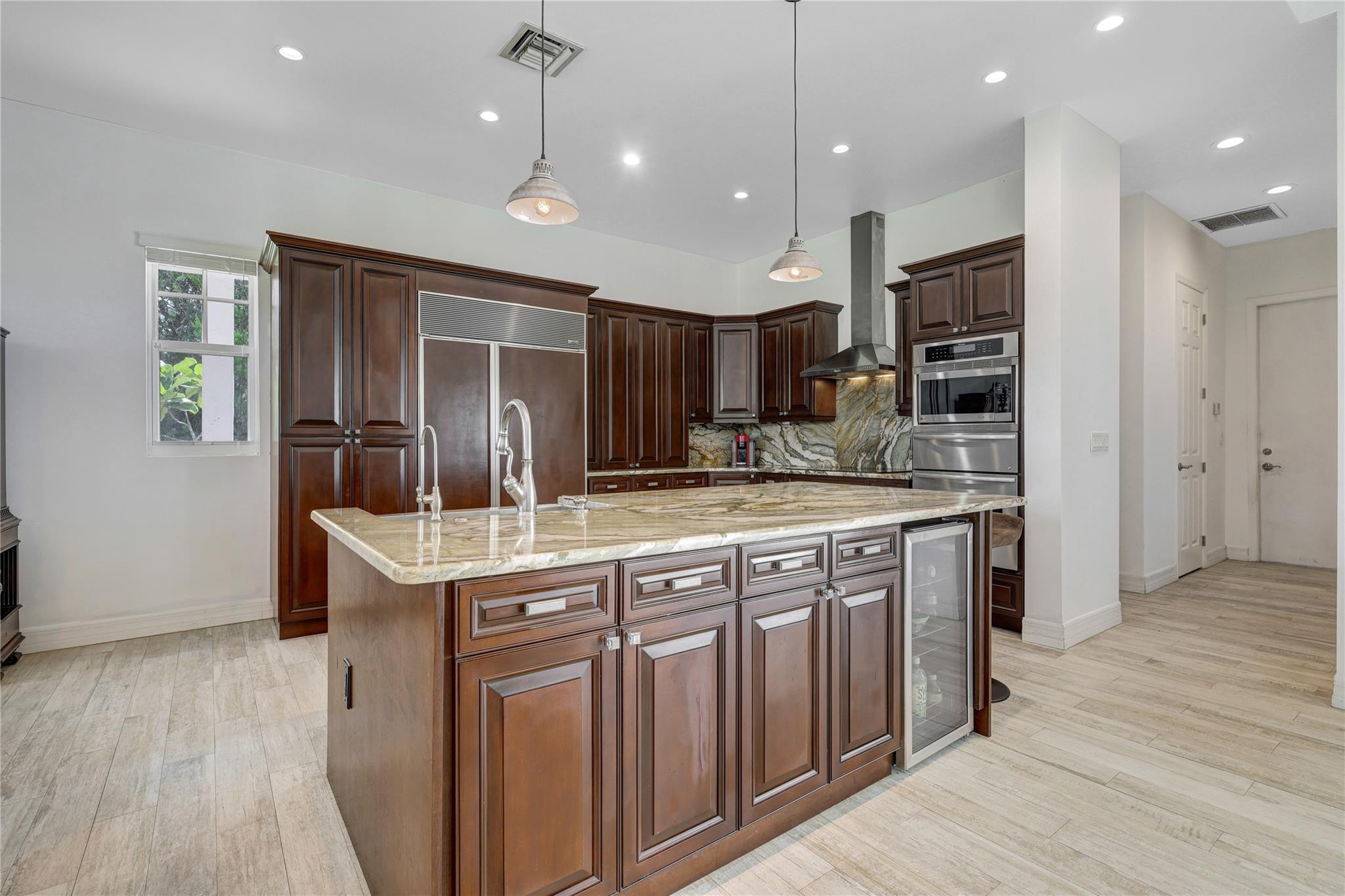 6601 Appaloosa Trail Southwest Ranches, FL 33330 - Photo 13 of 49 a kitchen with kitchen island granite countertop a sink and refrigerator