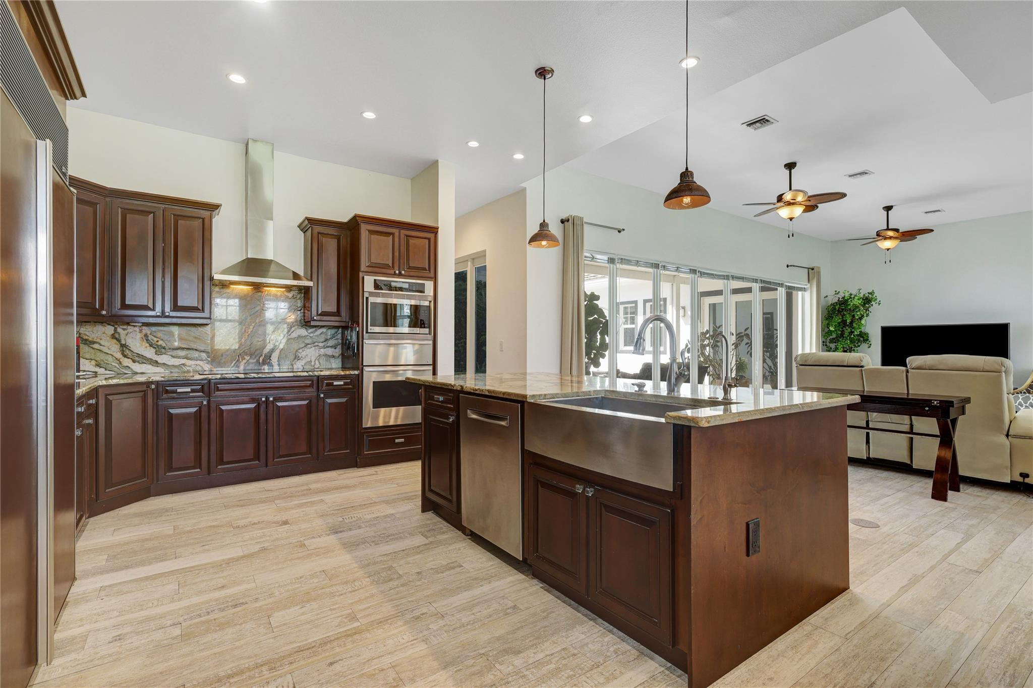 6601 Appaloosa Trail Southwest Ranches, FL 33330 - Photo 16 of 49 a kitchen with stainless steel appliances kitchen island granite countertop a stove and cabinets