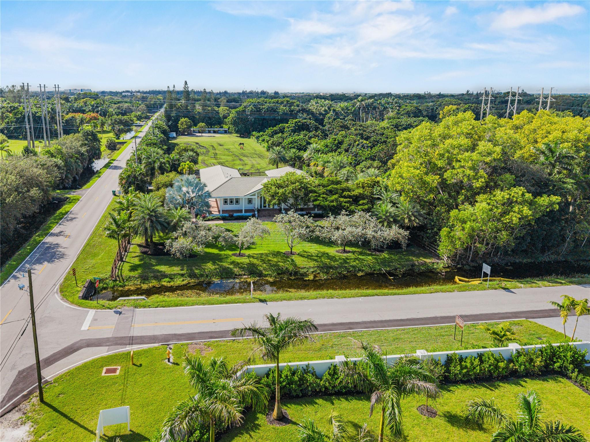 6601 Appaloosa Trail Southwest Ranches, FL 33330 - Photo 2 of 49 an aerial view of a houses with a yard and lake view