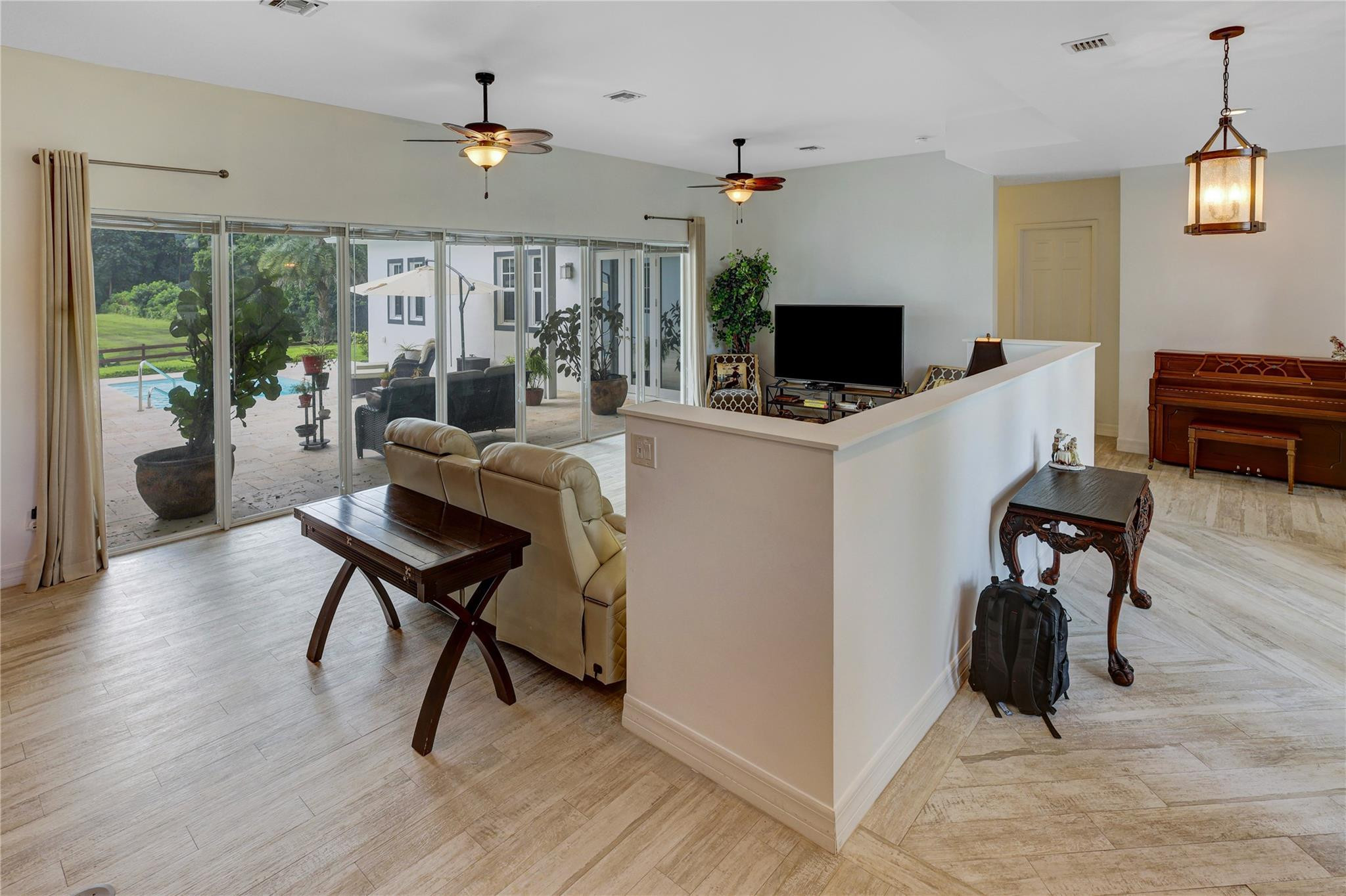 6601 Appaloosa Trail Southwest Ranches, FL 33330 - Photo 28 of 49 a living room with furniture a flat screen tv and a table
