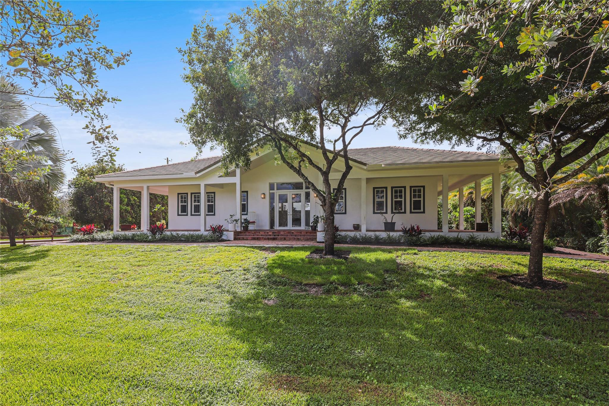 6601 Appaloosa Trail Southwest Ranches, FL 33330 - Photo 4 of 49 a front view of a house with yard patio and green space
