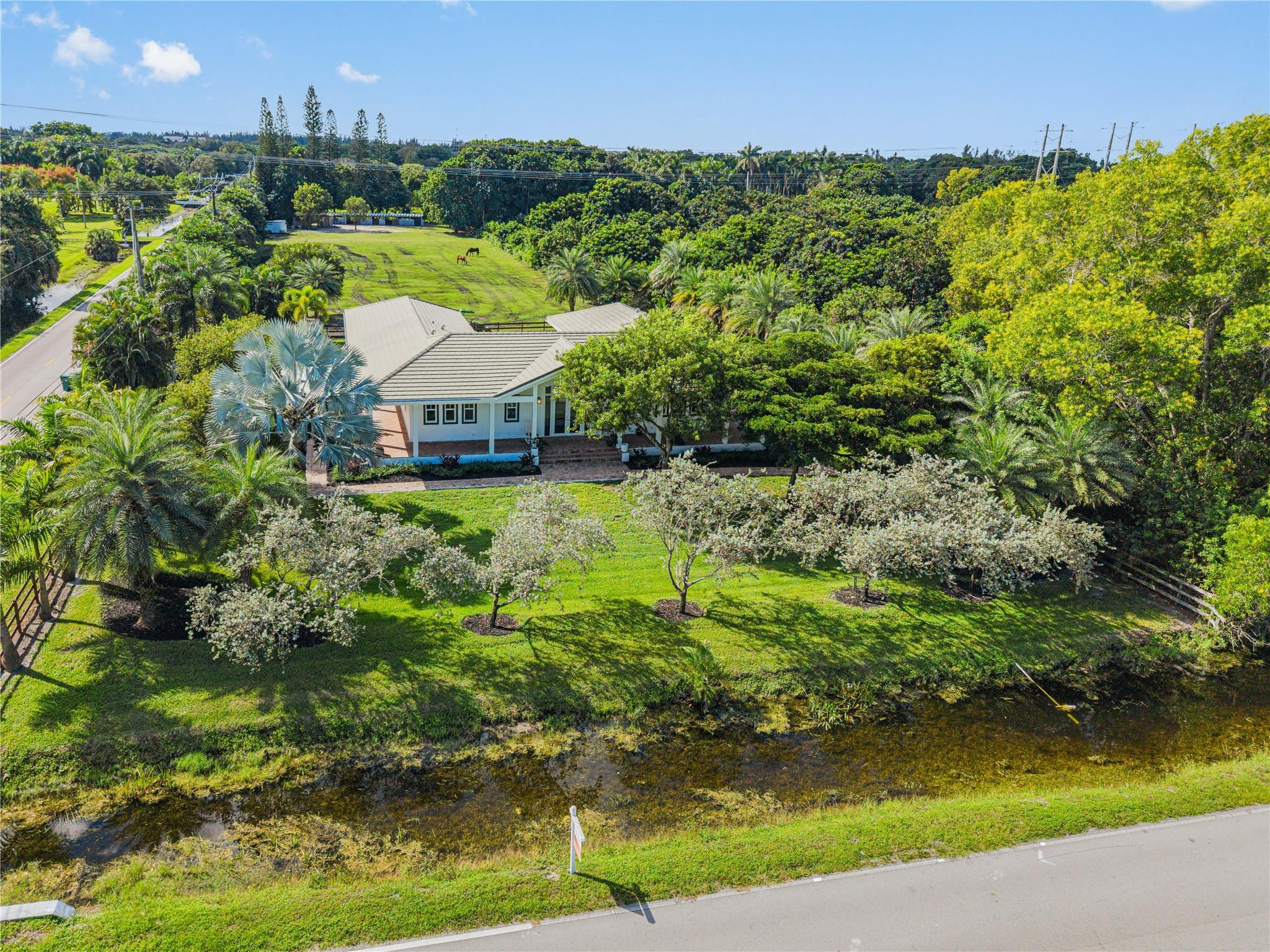 6601 Appaloosa Trail Southwest Ranches, FL 33330 - Photo 9 of 49 an aerial view of a house with a yard and lake view