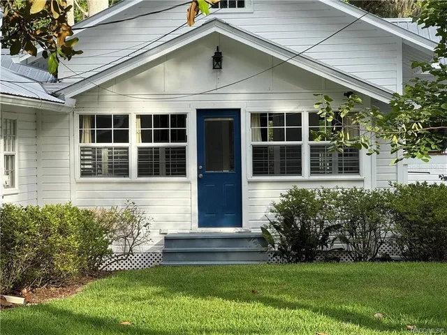 a view of backyard with a deck