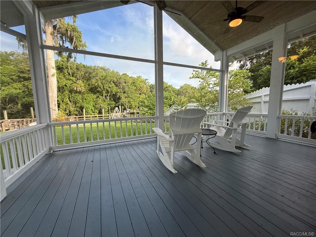 5217 Riverside Drive Yankeetown, FL 34498 - Photo 25 of 54 a view of a porch with furniture and wooden floor