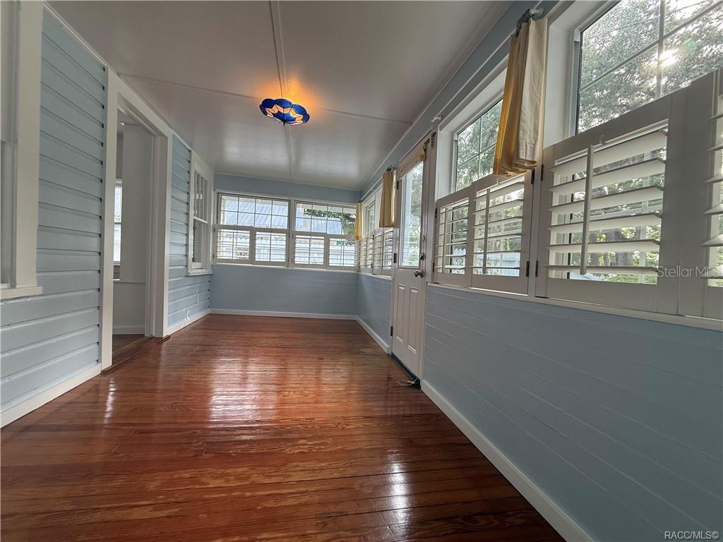 5217 Riverside Drive Yankeetown, FL 34498 - Photo 31 of 54 a view of an empty room with wooden floor and a window