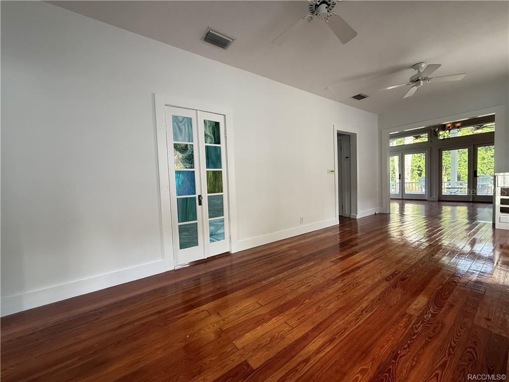 5217 Riverside Drive Yankeetown, FL 34498 - Photo 32 of 54 wooden floor in an empty room with a window