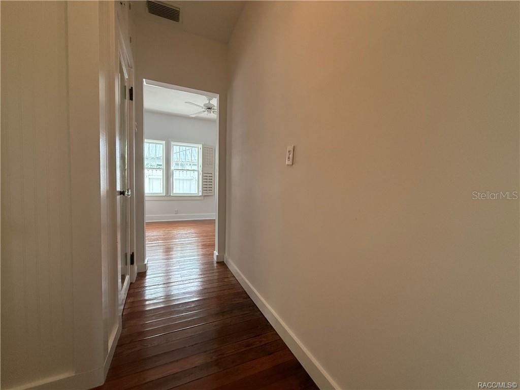 5217 Riverside Drive Yankeetown, FL 34498 - Photo 36 of 54 a view of a hallway with wooden floor