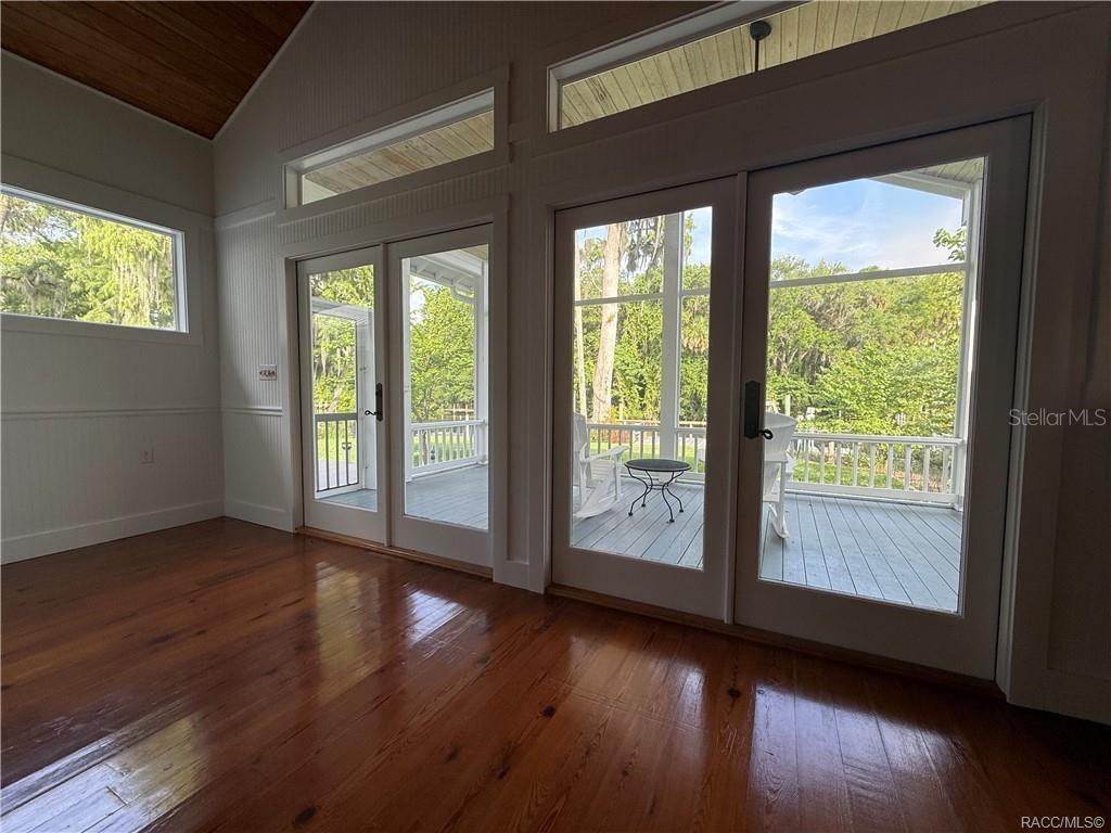 5217 Riverside Drive Yankeetown, FL 34498 - Photo 41 of 54 a view of an empty room with wooden floor and a window