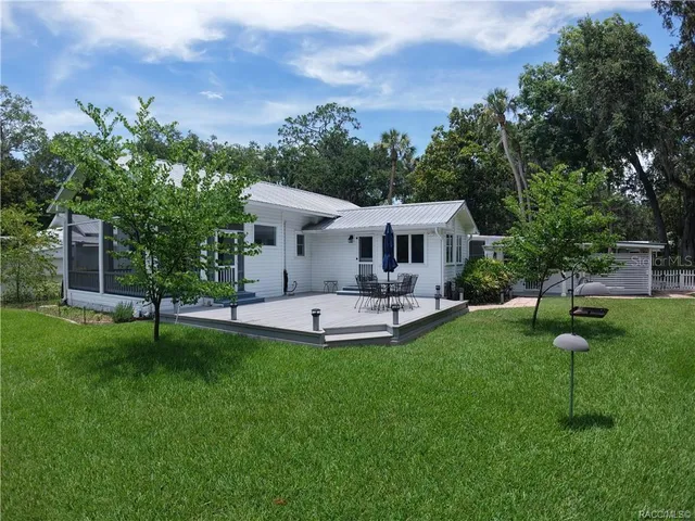 a view of a house with a backyard porch and sitting area