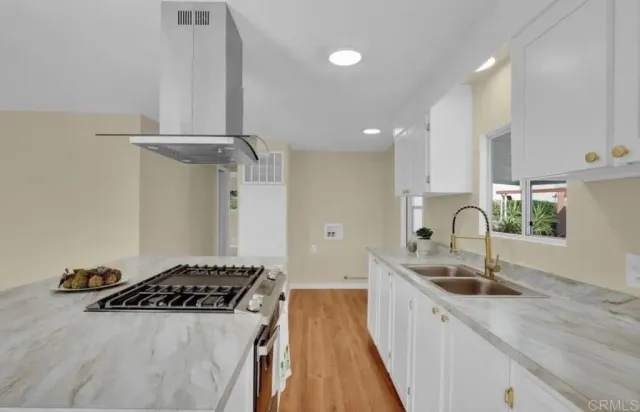 a kitchen with stainless steel appliances a sink a stove and a refrigerator