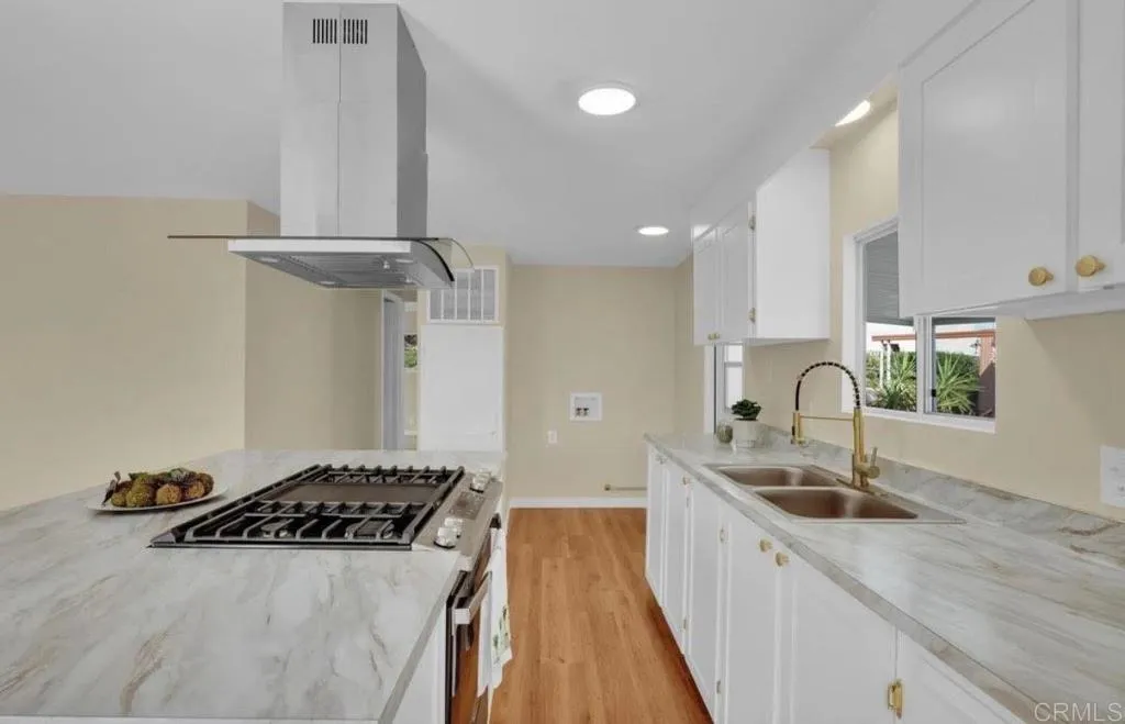a kitchen with stainless steel appliances a sink a stove and a refrigerator