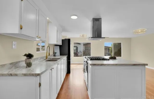 a kitchen with stainless steel appliances granite countertop a sink and stove