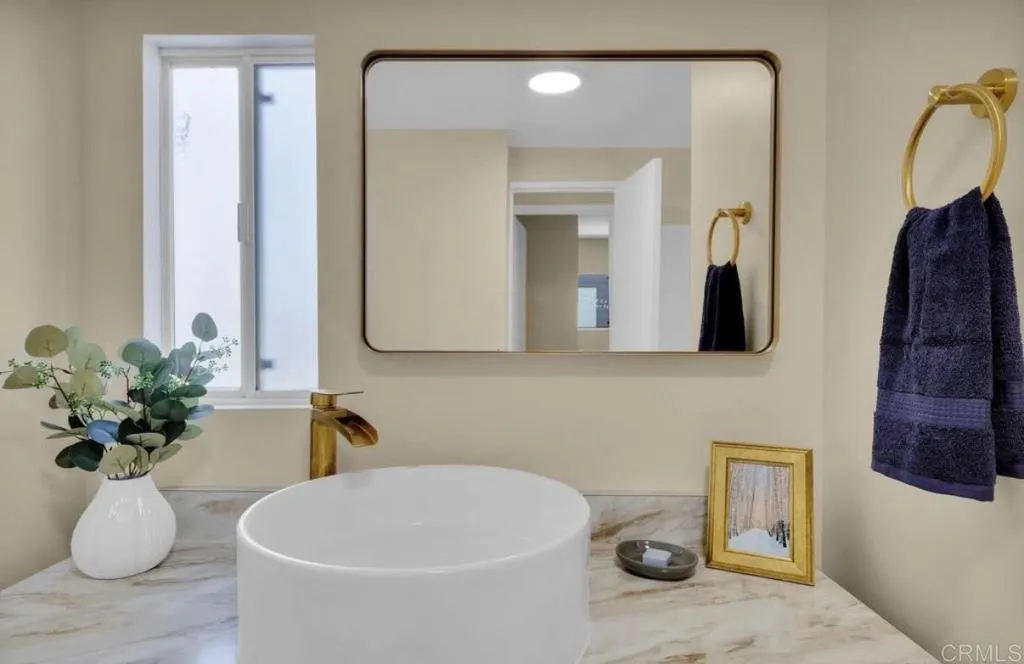 2515 Sweetwater Road, Unit 32 Spring Valley, CA 91977 - Photo 10 of 11 a bathroom with a sink a toilet and mirror