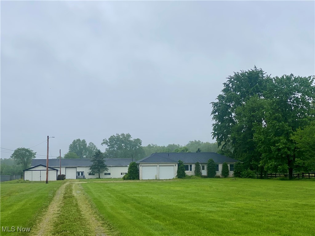 36889 Capel Road Grafton, OH 44044 - Photo 1 of 26 View of grassy yard with driveway and an attached garage