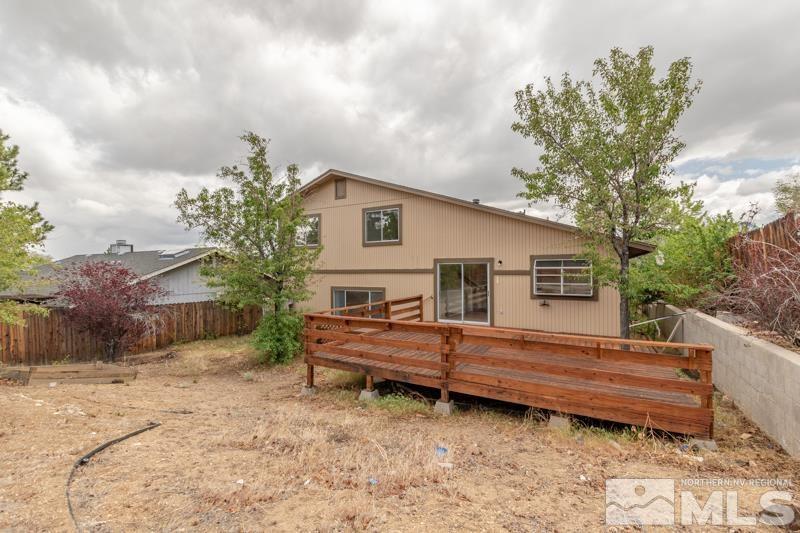 2635 Emily Street Reno, NV 89503 - Photo 23 of 23 a backyard of a house with wooden fence and large trees