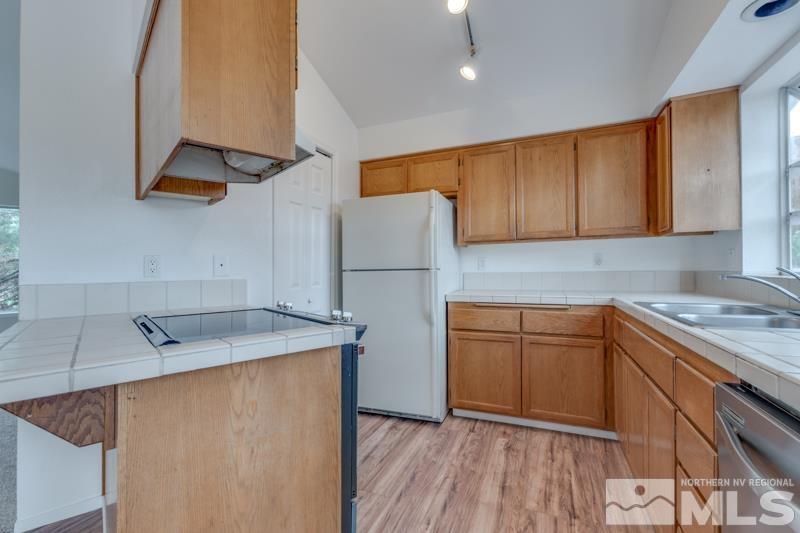 2635 Emily Street Reno, NV 89503 - Photo 7 of 23 a kitchen with stainless steel appliances granite countertop a sink stove and refrigerator