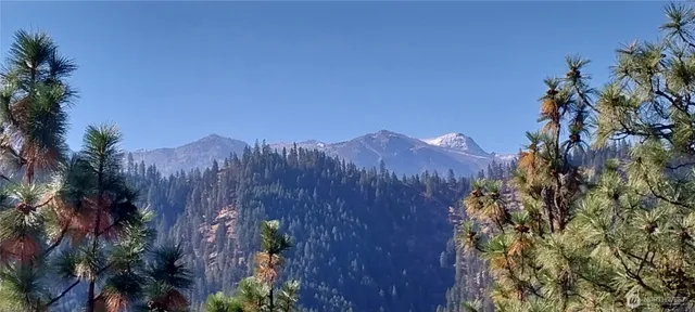 a view of a house with a mountain in the background