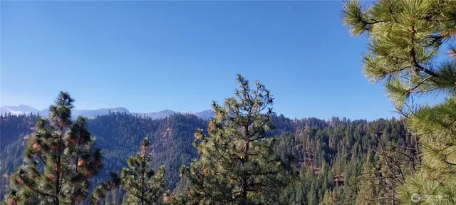 a view of a house with a mountain in the background
