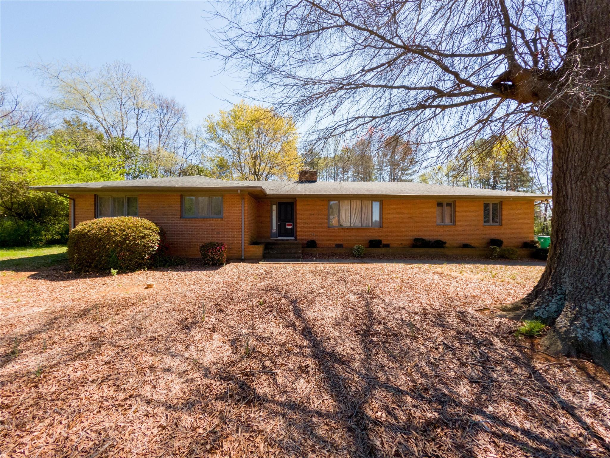 4910 Lakeview Road Charlotte, NC 28216 - Photo 1 of 26 a front view of a house with a yard