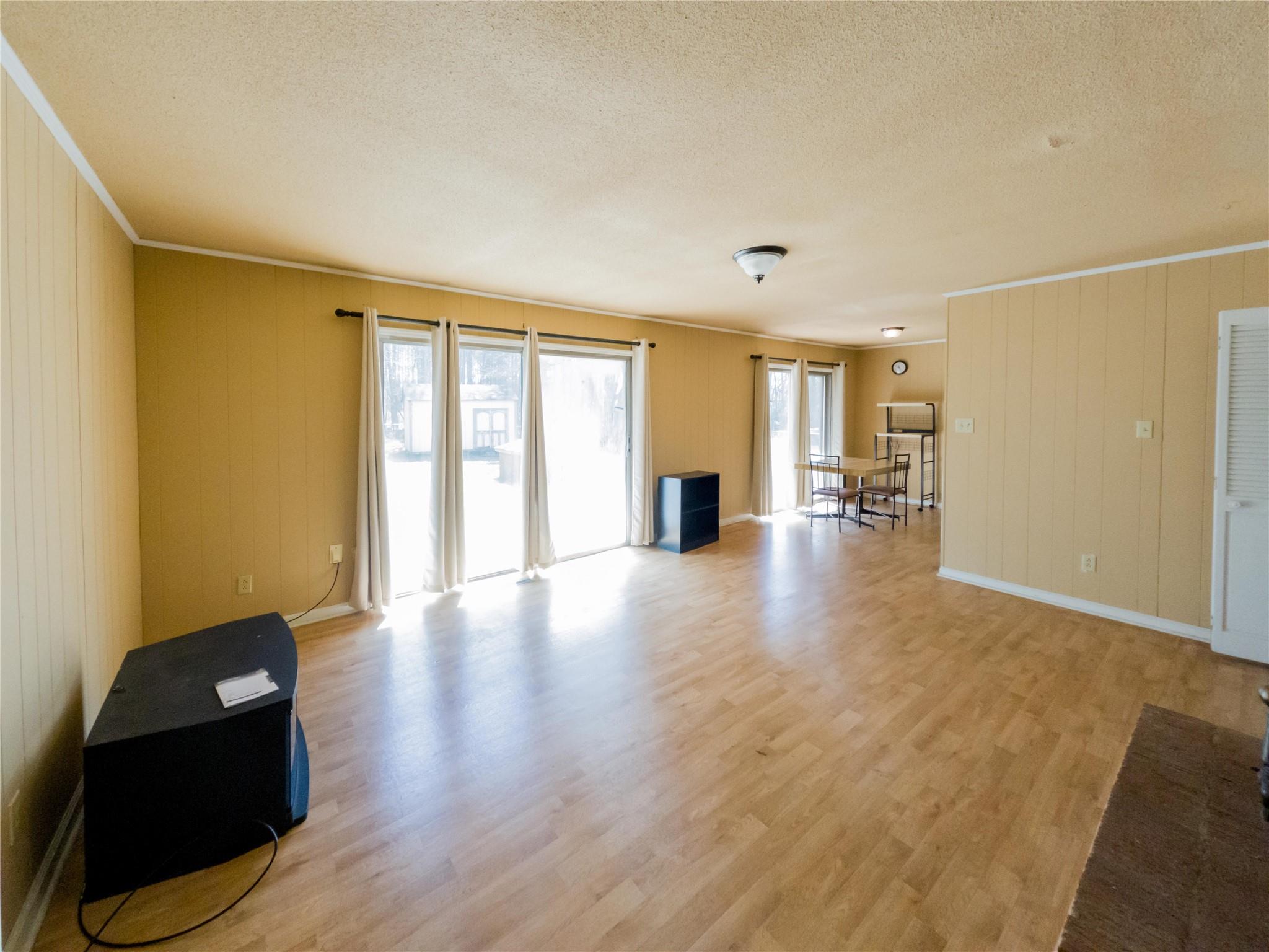 4910 Lakeview Road Charlotte, NC 28216 - Photo 11 of 26 a view of an empty room with wooden floor and a window