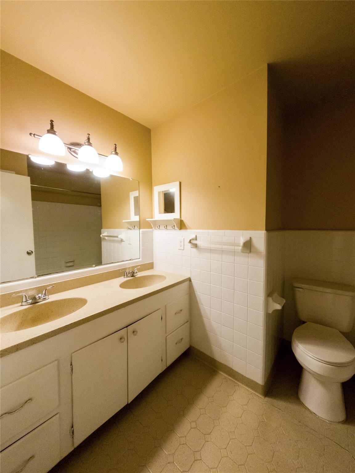 4910 Lakeview Road Charlotte, NC 28216 - Photo 16 of 26 a spacious bathroom with a double vanity sink and a mirror